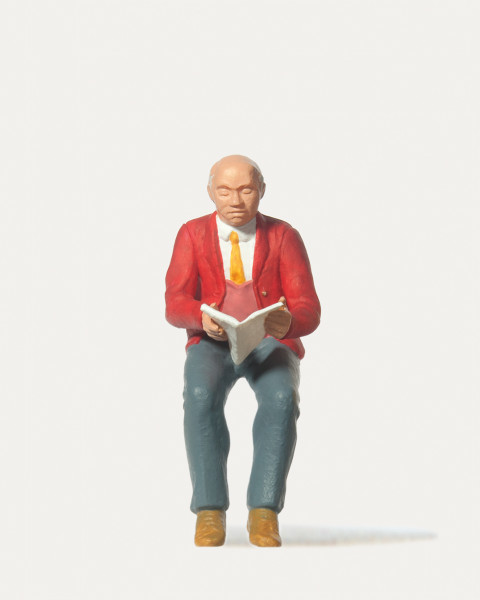 Sitzender Zeitungsleser mit roter Jacke